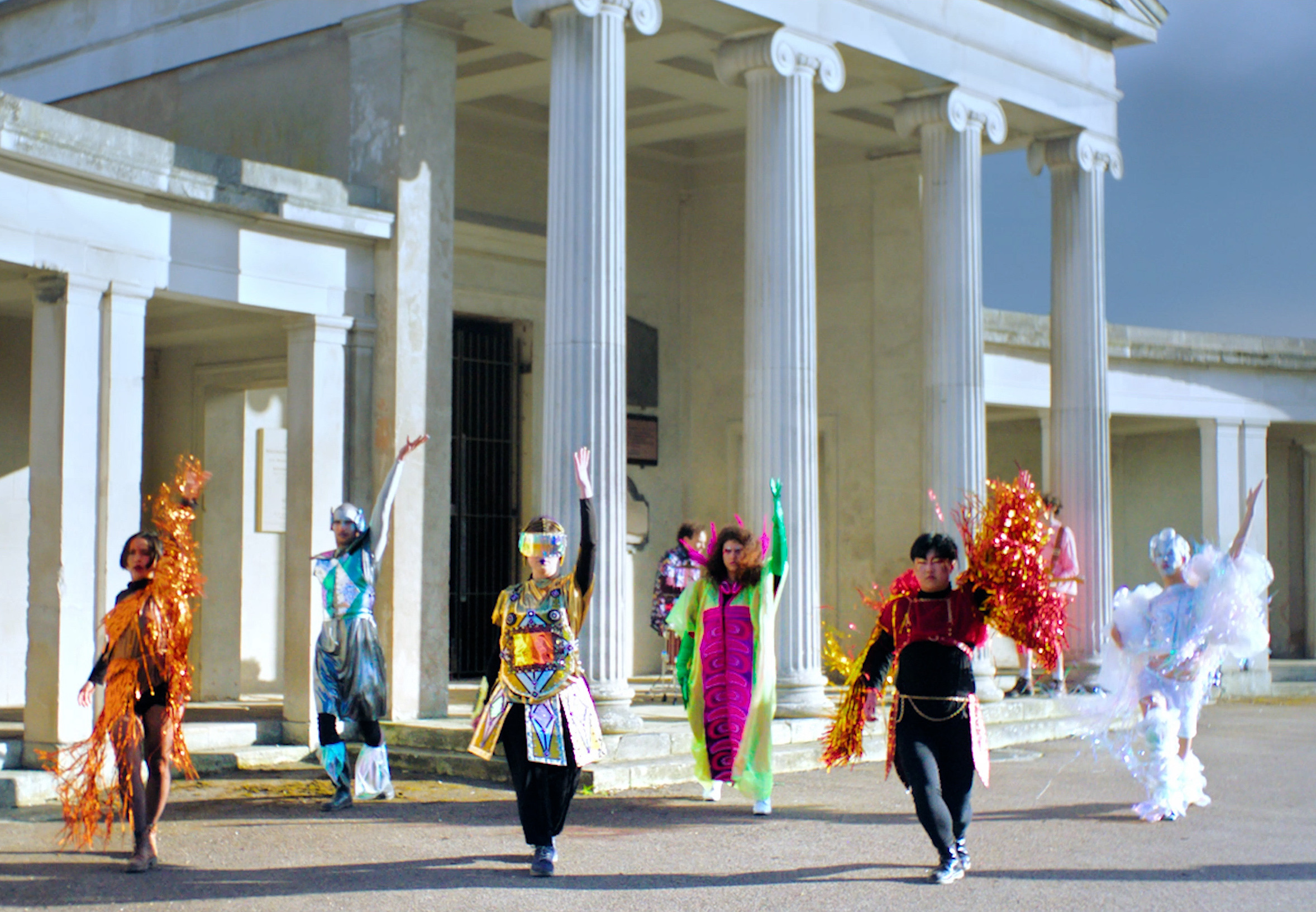 Six non-binary deity characters in costume, left to right: Memory and Death, Home/Less/Ness, Cyborgism and Online Community, Nature Regeneration, Mischief and Masking, and Neuro/Plasticity — Forgotten Stories pantheon group photo.